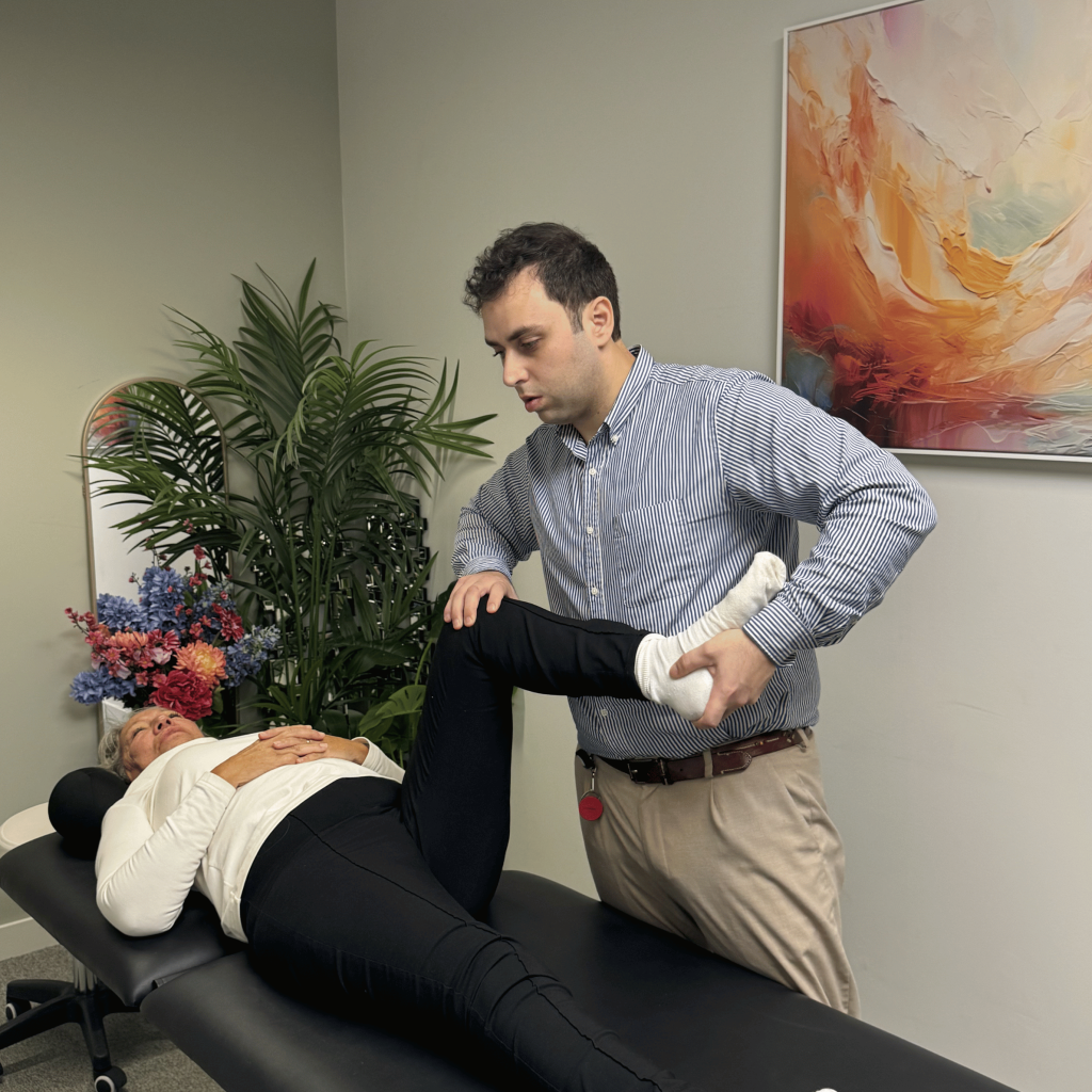 Chiropractor stretching a patient’s leg for hip and knee pain at Mayfair & Belgravia Chiropractic