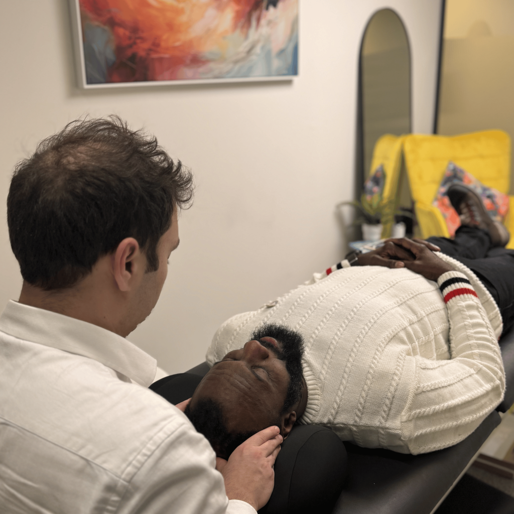 Chiropractor performing a neck adjustment on a patient at Mayfair & Belgravia Chiropractic