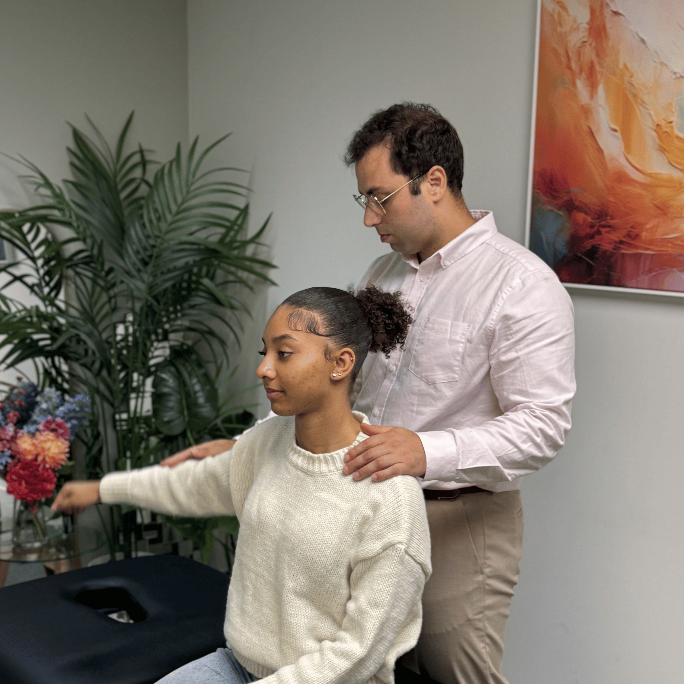 top insuranceChiropractor assessing a shoulder and arm at Mayfair & Belgravia Chiropractic