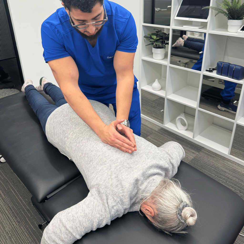 Chiropractor treating a patient’s leg for sciatica at Mayfair & Belgravia Chiropractic