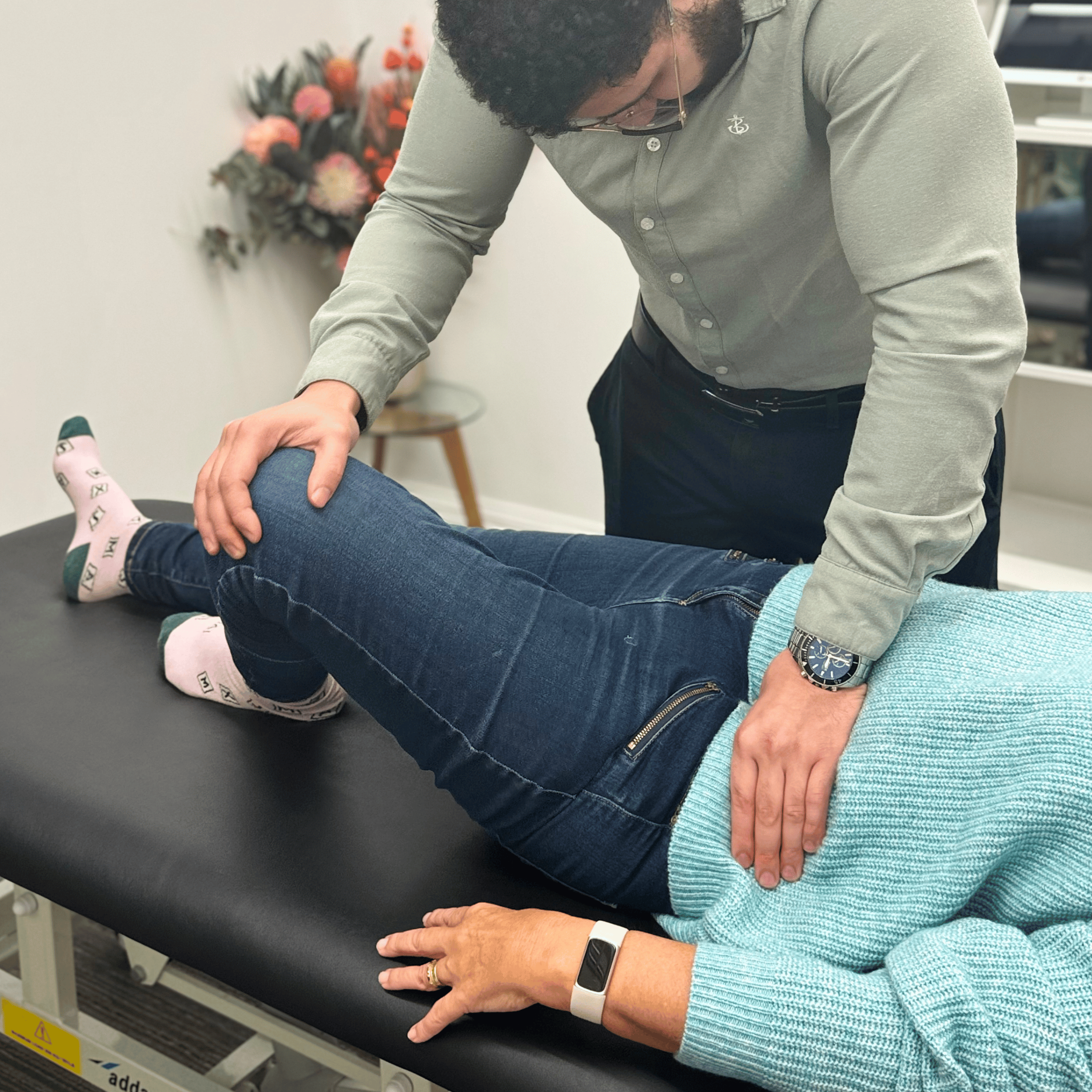 Chiropractor treating a patient’s knee and hip mobility at Mayfair & Belgravia Chiropractic